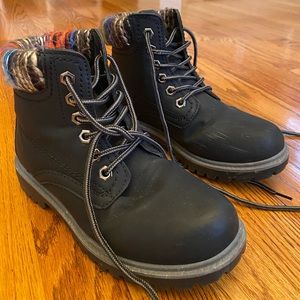 Black booties with warm colors on heel.